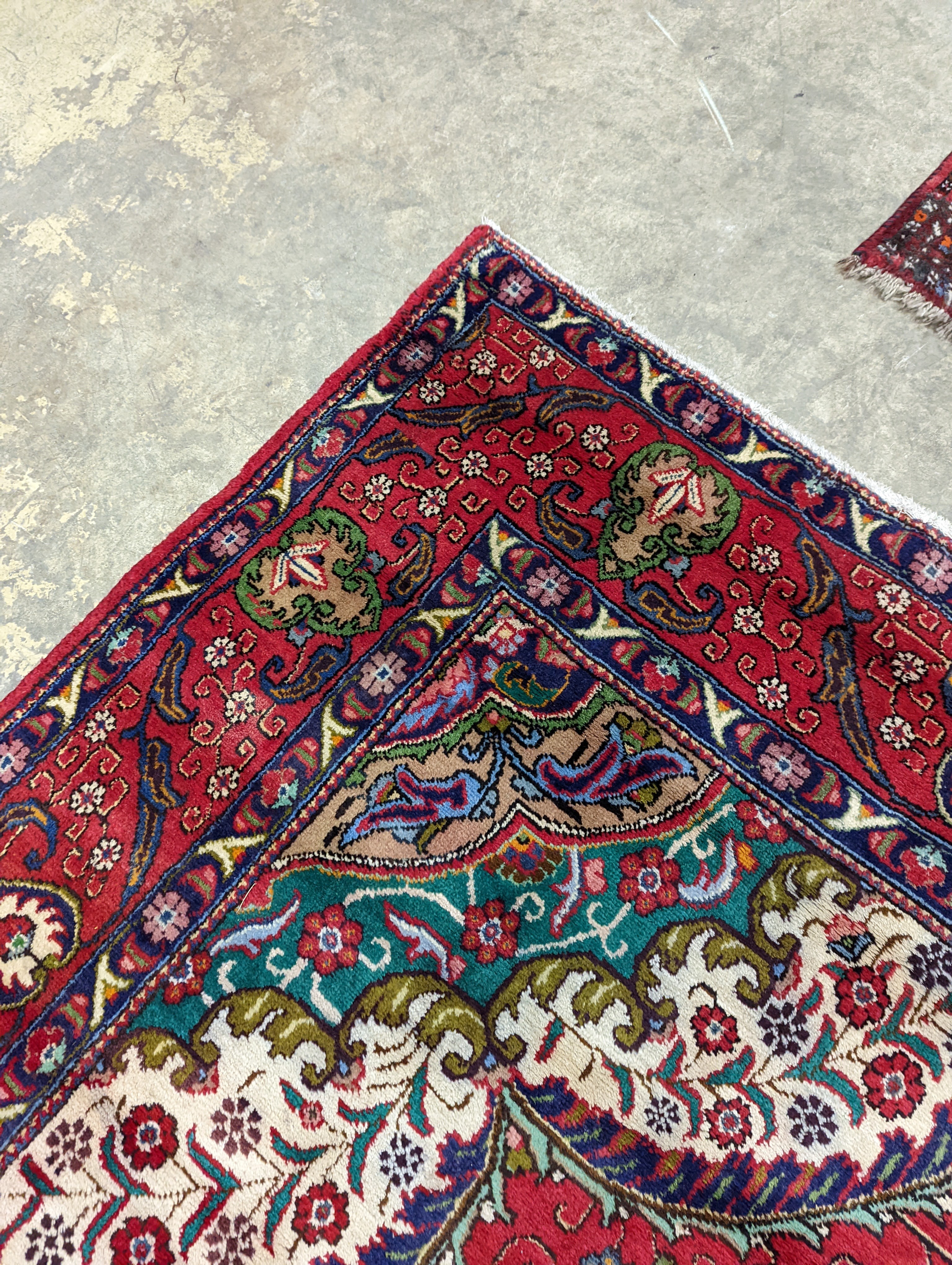 A Tabriz red ground carpet, 380 x 300cm